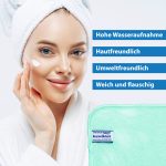 Cropped shot of pretty young woman applies cream for rejuvenation, healthy soft skin, uses cosmetic product, demonstrates nice effect of body lotion, wears comfortable soft white bath robe, towel